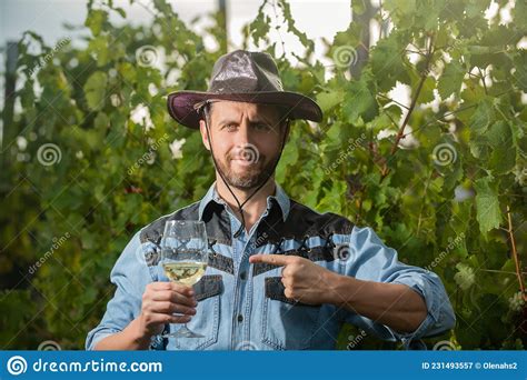 Happy Viticulturist Man Farmer Point Finger On Wine At Grape Farm