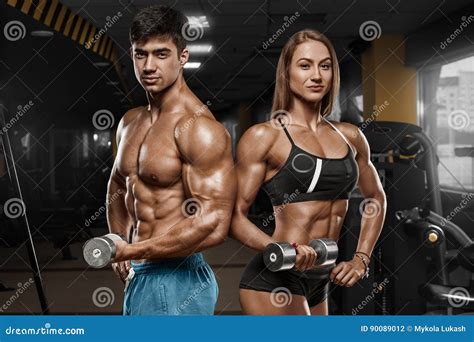 Sporty Couple Showing Muscle And Workout In Gym Muscular Man And Wowan