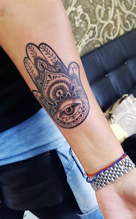 This buddha tattoo is on the arm, it feels like a bronze statue; Buddha Hand Tattoo - Radical Ink