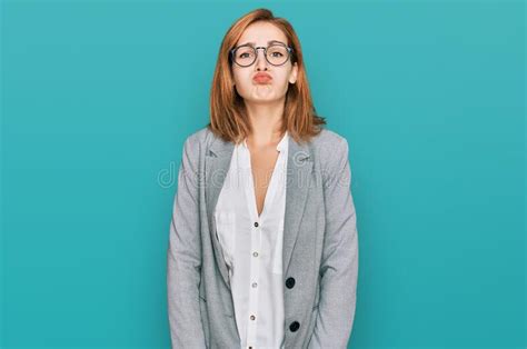 Young Caucasian Woman Wearing Business Style And Glasses Puffing Cheeks