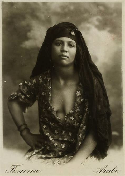 An Old Black And White Photo Of A Woman With Long Hair Wearing A Headdress