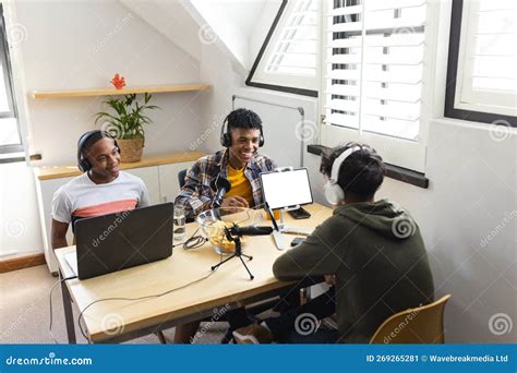 Image Of Happy Diverse Teenage Boys With Headphones And Laptops At Home