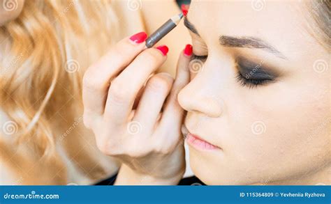 Closeup Image Of Makeup Artist Painting Model S Eyebrows With