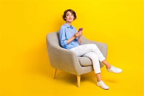 full length photo of dreamy thoughtful girl dressed blue shirt chatting modern gadget looking