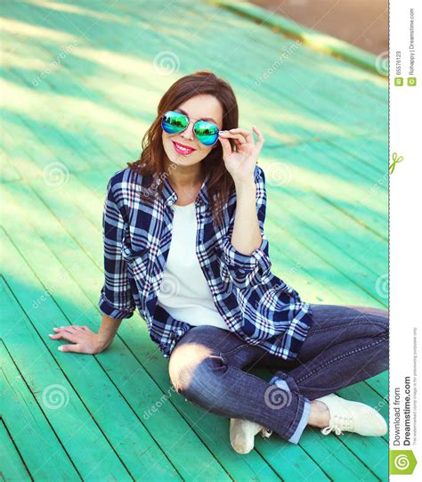 Pretty Woman Wearing A Sunglasses And Checkered Shirt Stock Image