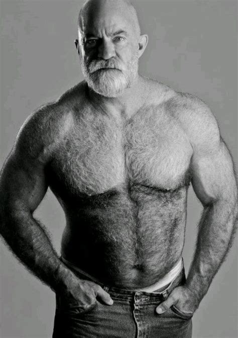 An Old Man With No Shirt On Posing For A Black And White Photo In Jeans