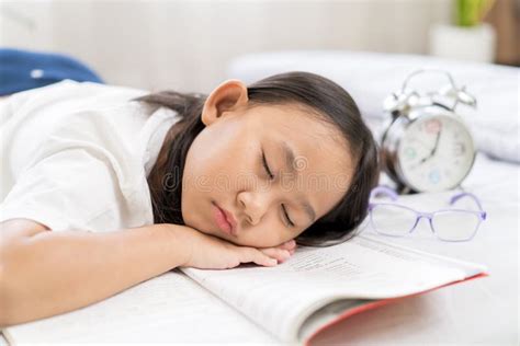 Asian Child Little Girl Sleep Tired From Reading A Book Stock Photo