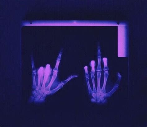 Two Hands That Are In The Dark With Blue Light On Them And One Is