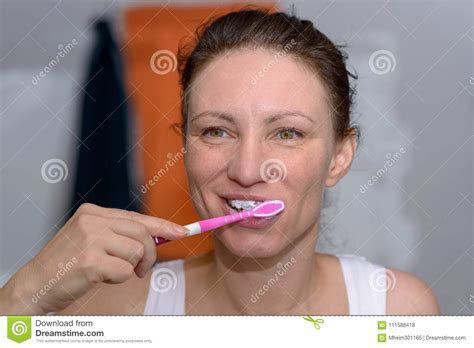 Happy Woman Brushing Her Teeth With A Toothbrush Stock Photo Image Of
