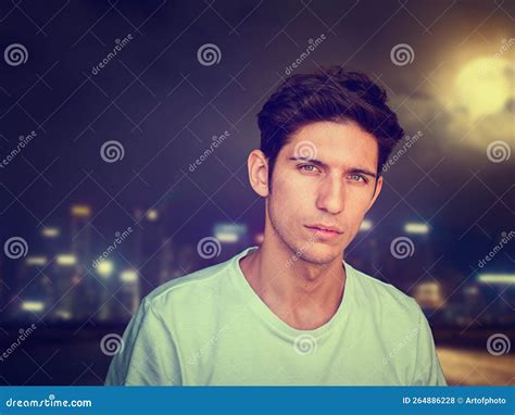 Handsome Trendy Young Man Standing Outside At Night Stock Photo