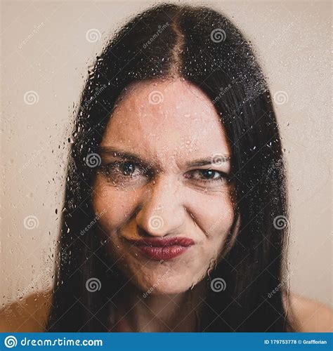 Girl With Dark Long Hair And Red Lips Pressing Her Nose Against A Wet