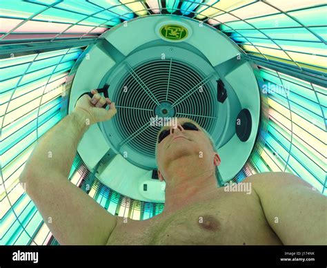 Man In A Stand Up Uv Tanning Booth Stock Photo Alamy