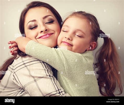 Beautiful Kid Girl And Mother Hugging With Closed True Enjoying Toned