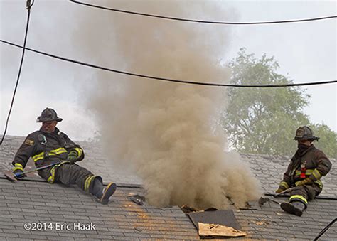 Firefighter On Roof Ventilating