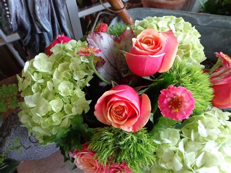 Mix Of Hydrangeas Cherry Brandy Roses And Green Trick Dianthus In Leaf Lined Hurricane Cylinder