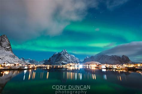 Northern Lights Aurora Borealis Fill Night Sky Over Reine Lofoten