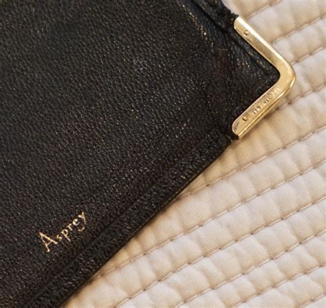 Make a great first impression and keep your business cards in perfect condition with this sleek gold plated business card holder. Rare Asprey London, 1930s 9-carat Gold Black Leather ...