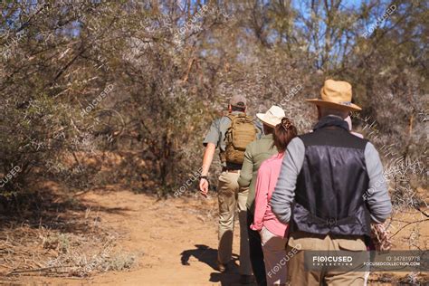 Safari Tour Guide Leading Group In Sunny Grassland South Africa — Woman