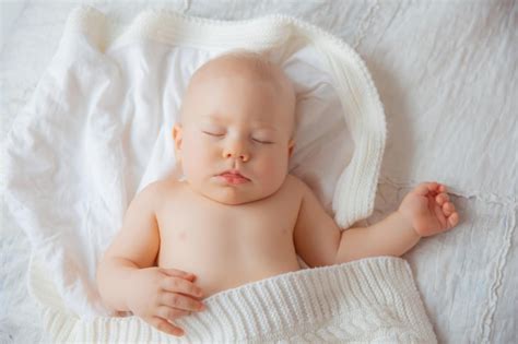 Premium Photo Baby Boy Is Sleeping On Bed Covered With A White
