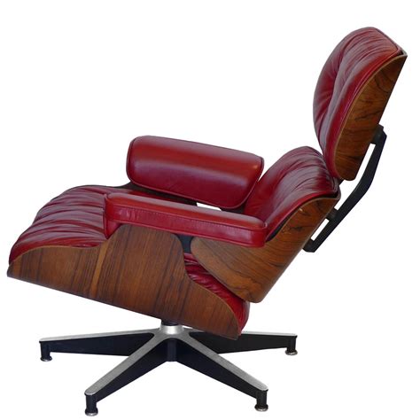 These chairs boast a plastic seat and wooden legs with metal supports. Custom Red Rosewood Eames 670 Chair & 671 Ottoman | TFTM ...