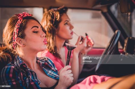 Beautiful Pinup Girls Driving In The Vintage Care And Putting Makeup