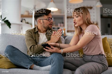 Boyfriend And Girlfriend Are Arguing On The Couch Stock Photo