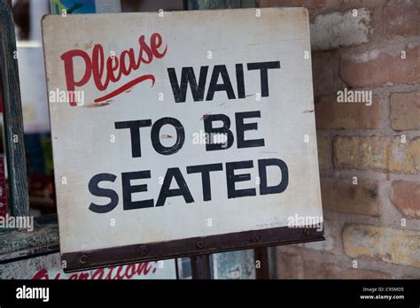 Please Wait To Be Seated Sign Stock Photo Alamy