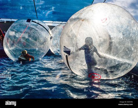Children Play In Water Bubbles Large Inflated Balls Floating In A Pool