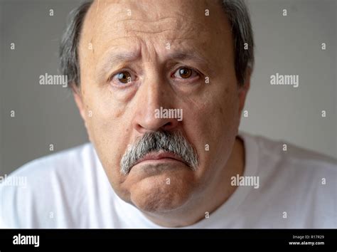 Portrait Of Older Adult Senior Man In Pain With Sad And Exhausted Face In Human Emotions Facial