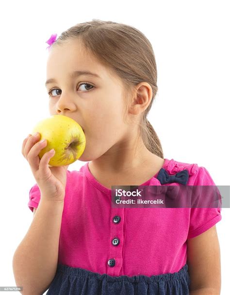 Little Girl Eating Apple Isolated On White Background Stock Photo
