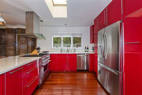Red really pops when paired with white cabinets and black surfaces. 29 Red Kitchen Ideas for 2018