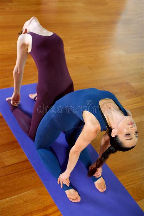 Two Young Fitness Women Doing Paired Yoga Exercises In The Training Room Healthy Lifestyle