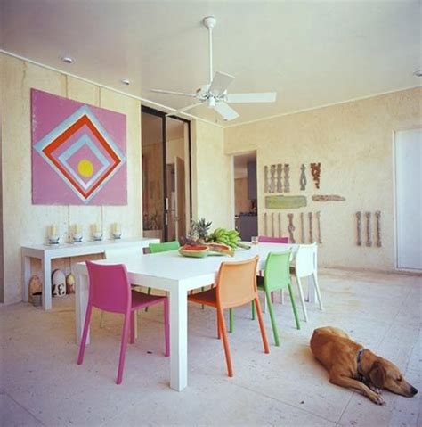 Again, an elegant dining room featuring a red, black and white palette. Colorful Dining Room with Multicolored Chairs