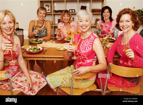 Portrait Of A Group Of Mature Women Sitting At The Dining Table And