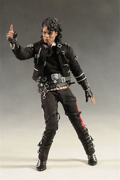 The Action Figure Is Dressed In Black And Has Chains On His Arms As He