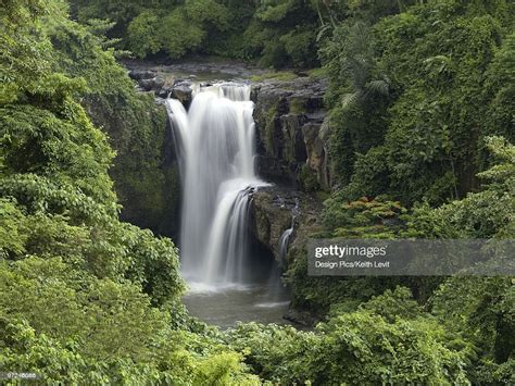 Waterfall Flowing Into A River Bali Indonesia High Res Stock Photo