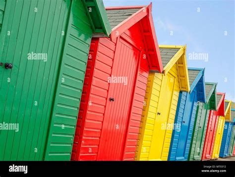 A Row Of Individually Coloured Beach Huts Stock Photo Alamy
