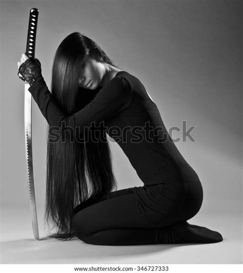 Sexy Long Haired Ninja Girl Or Assassin Woman Kneeling And Holding