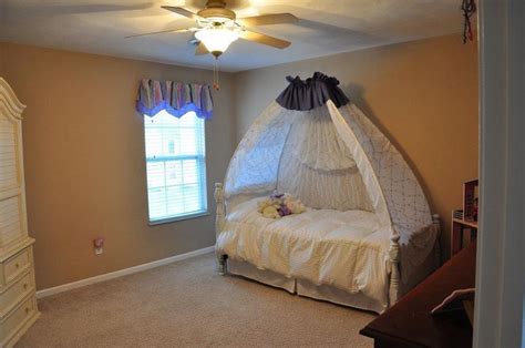 I don't think she minds! DIY Princess Canopy bed for under 25.00......See Link ...