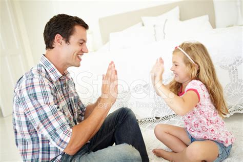 Father And Daughter Playing Together In Bedroom Stock Photo Royalty