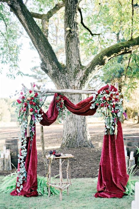 simple outdoor wedding ceremony decor consisted of greenery garland