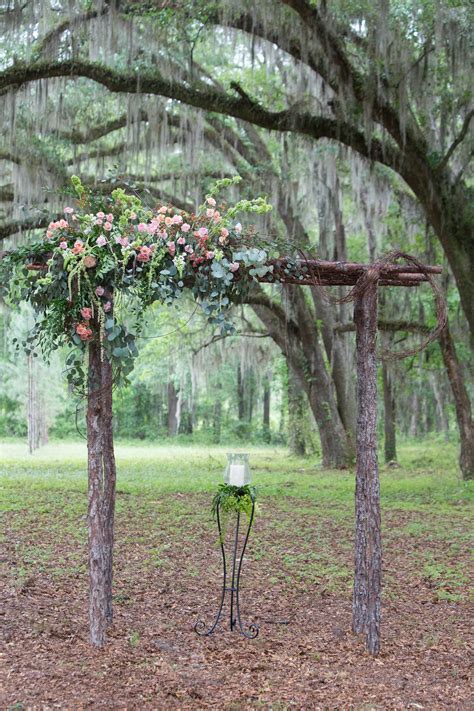 Natural Wooden Wedding Arch With Whimsical Greenery