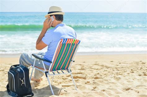 Man Chilling On The Beach Talking On Smartphone Back Side View Of Guy