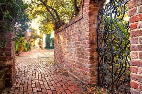 Brick Alleyway And Garden Gate Charleston Sc In The Background Is A