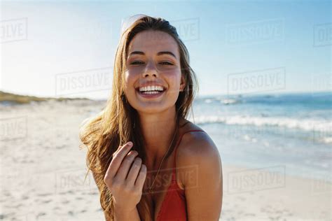 Portrait Of Smiling Young Woman On The Beach On A Sunny Day Young Caucasian Female Model In
