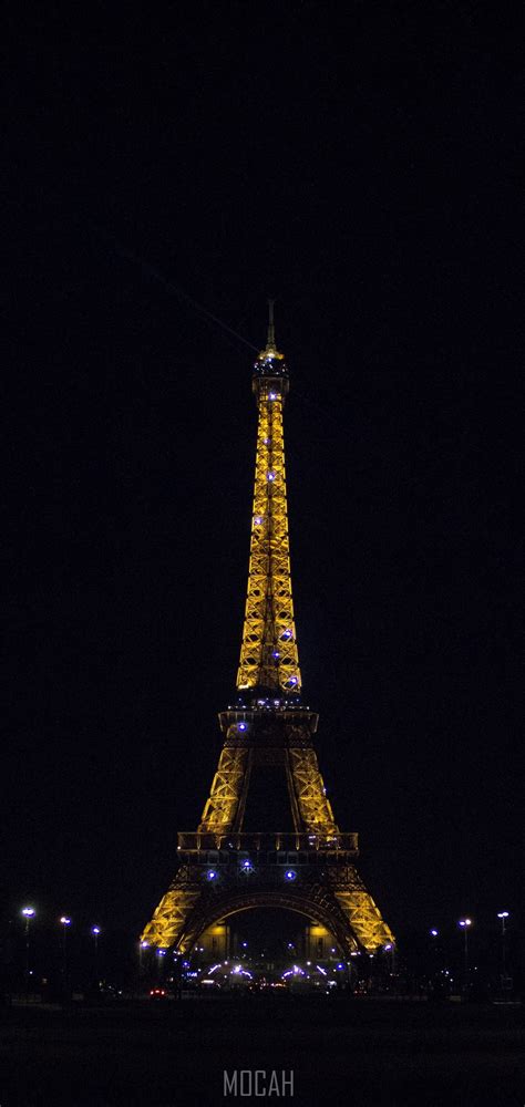 A Complete View Of The Eiffel Tower Illuminated At Night In Paris