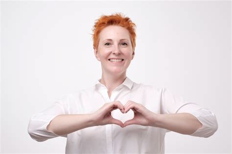 Premium Photo Mature Redhead Woman In A White Shirt