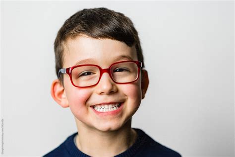 Studio Portrait Of A Smiling Child With Glasses by Giorgio Magini - Child, Portrait