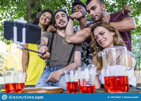 Multiethnic Group Of Millennial Friends Take A Selfie Outdoors Stock