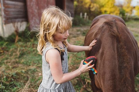 Young Girl Petting Her Pony By Stocksy Contributor Carey Shaw Stocksy